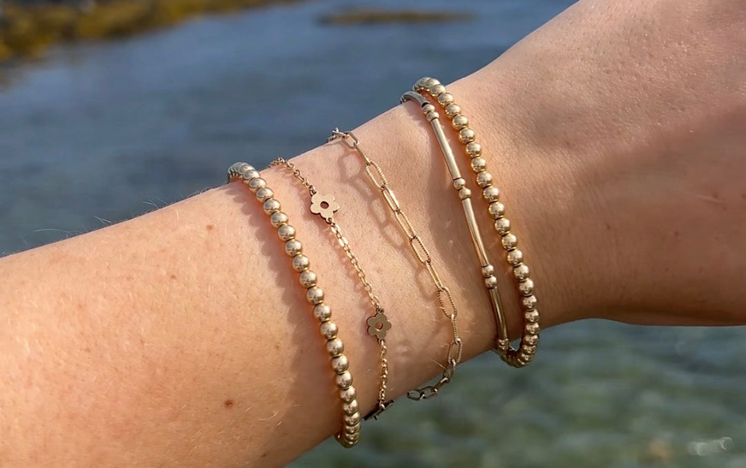 gold-filled bracelets with ocean in background